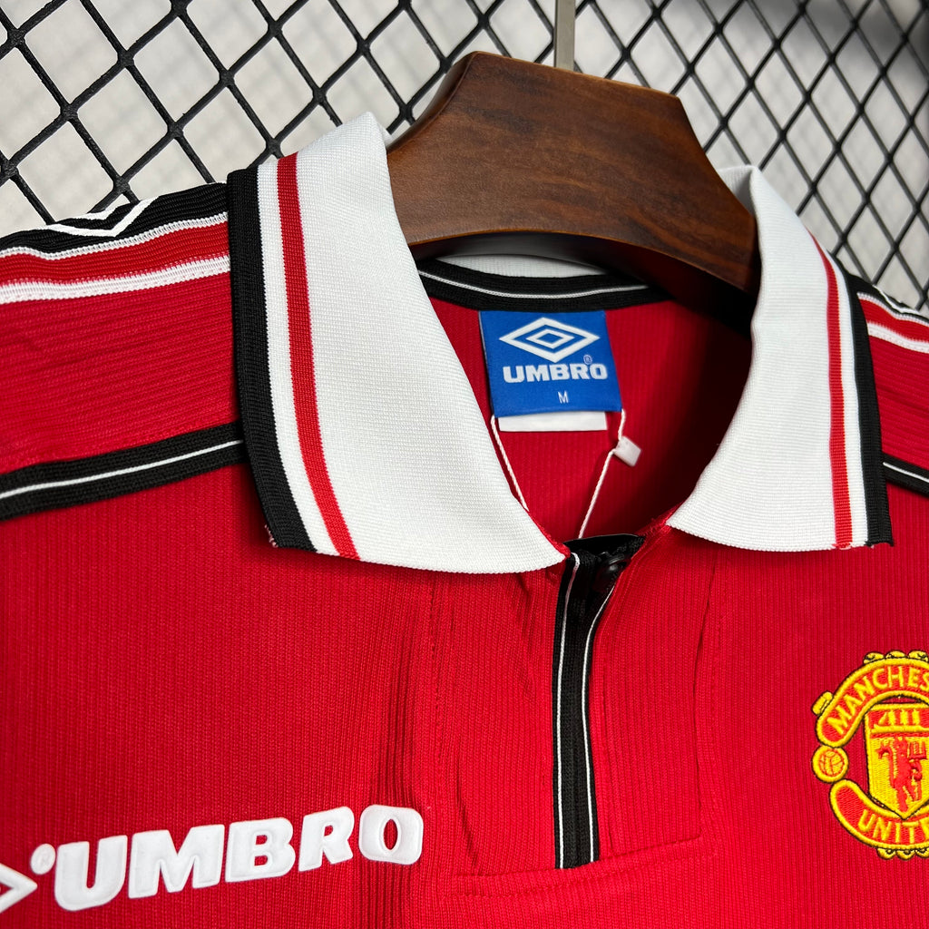 Red soccer jersey collar with white-and-red ribbed trim and Umbro logo at neckline