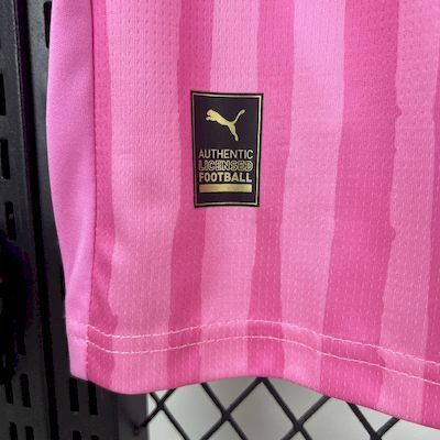 Pink goalkeeper jersey hem with Puma authenticity label