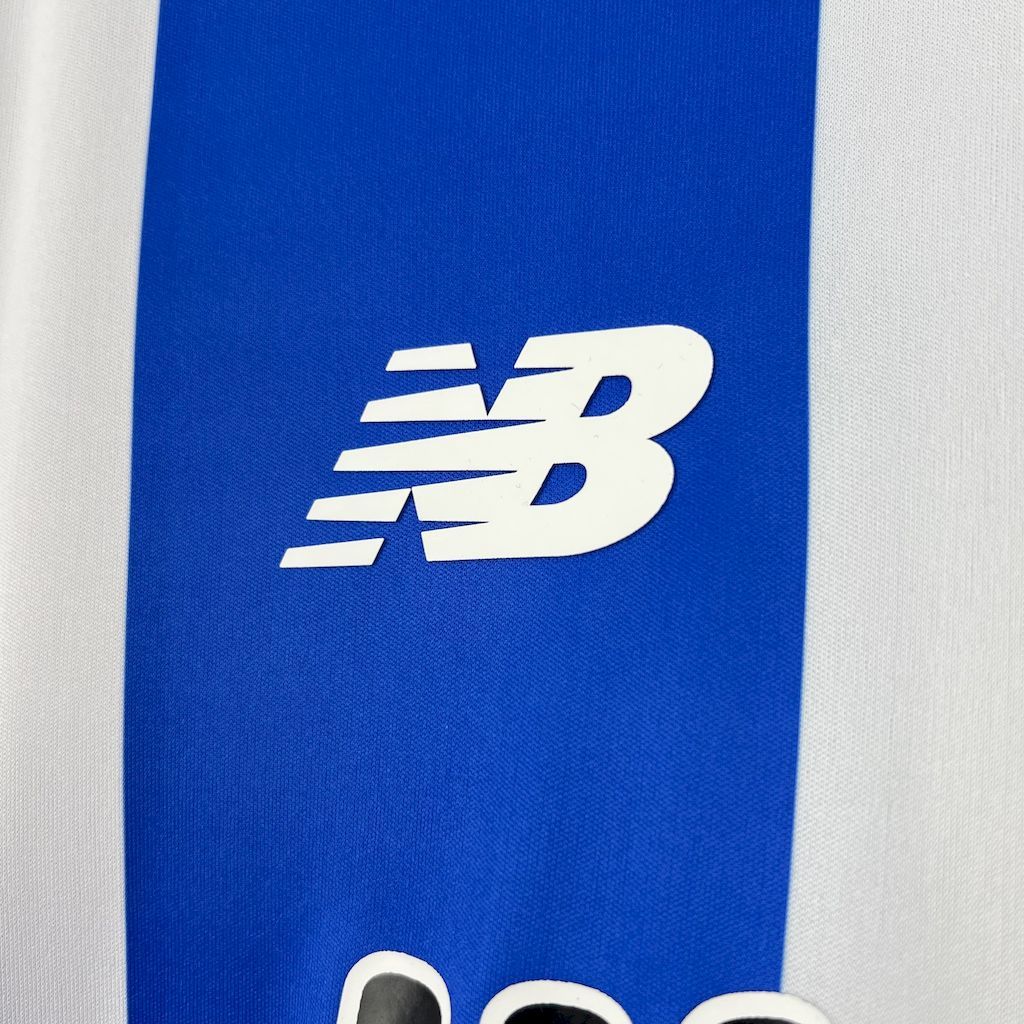 New Balance logo on blue side panel of retro soccer jersey