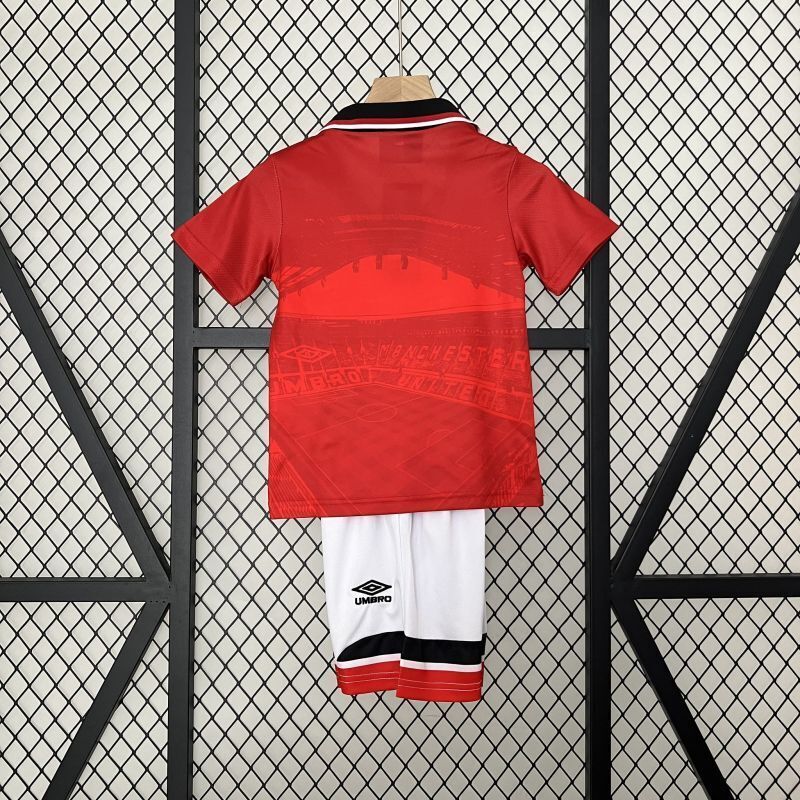 Back view red kid soccer jersey with black collar trim and white shorts