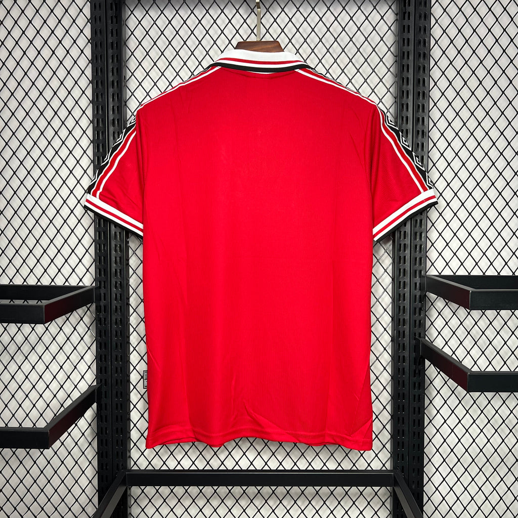 Red soccer jersey back view with white collar trim and black-and-white sleeve stripes