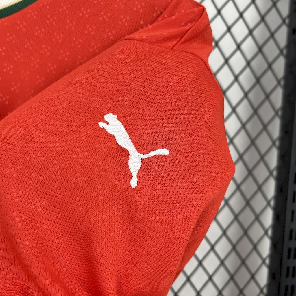 Red long-sleeve jersey with white Puma cat logo on sleeve