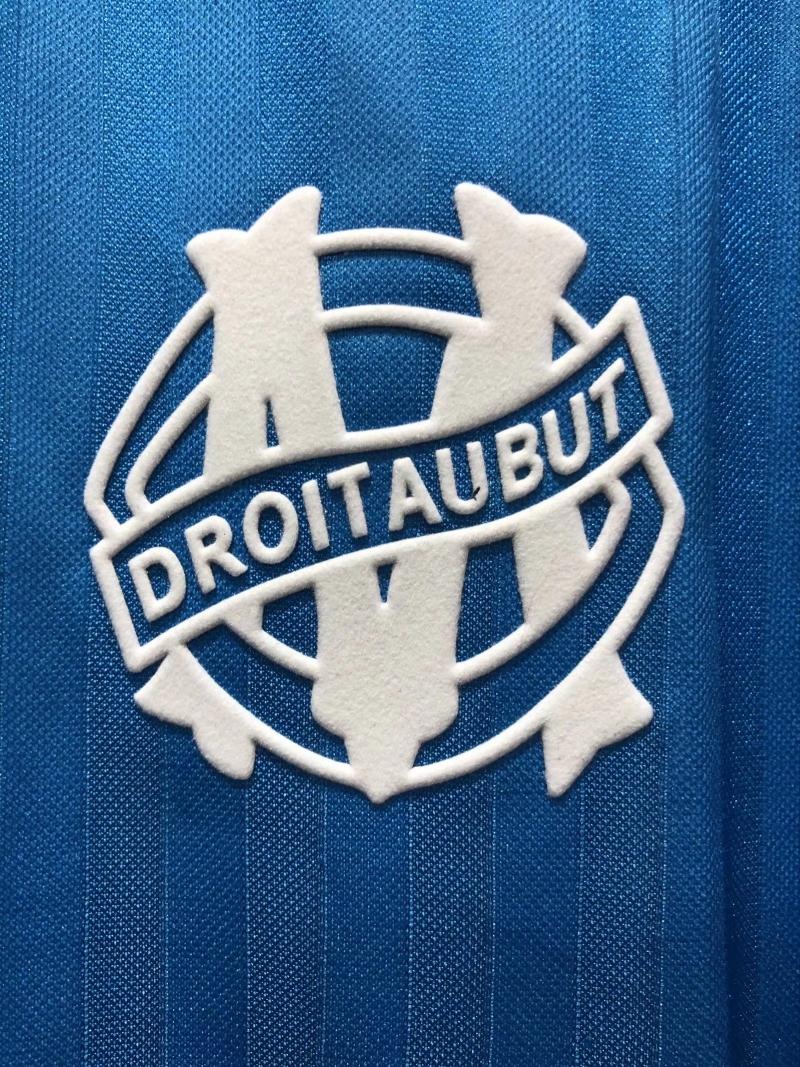 White Droit AUBUT crest logo on blue retro soccer jersey