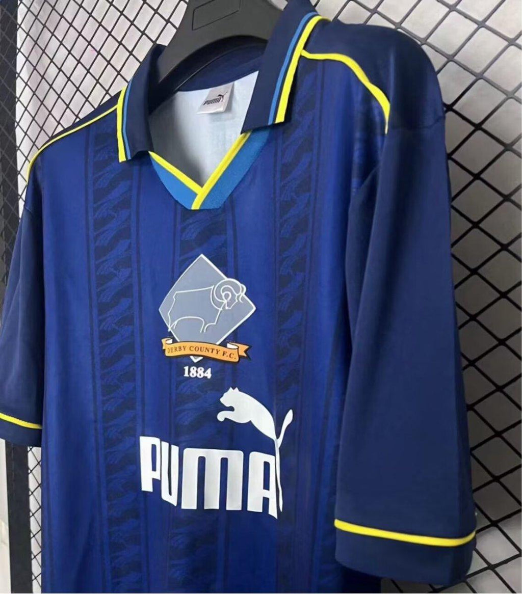 Blue retro away jersey with yellow collar trim, Puma logo and Derby County crest