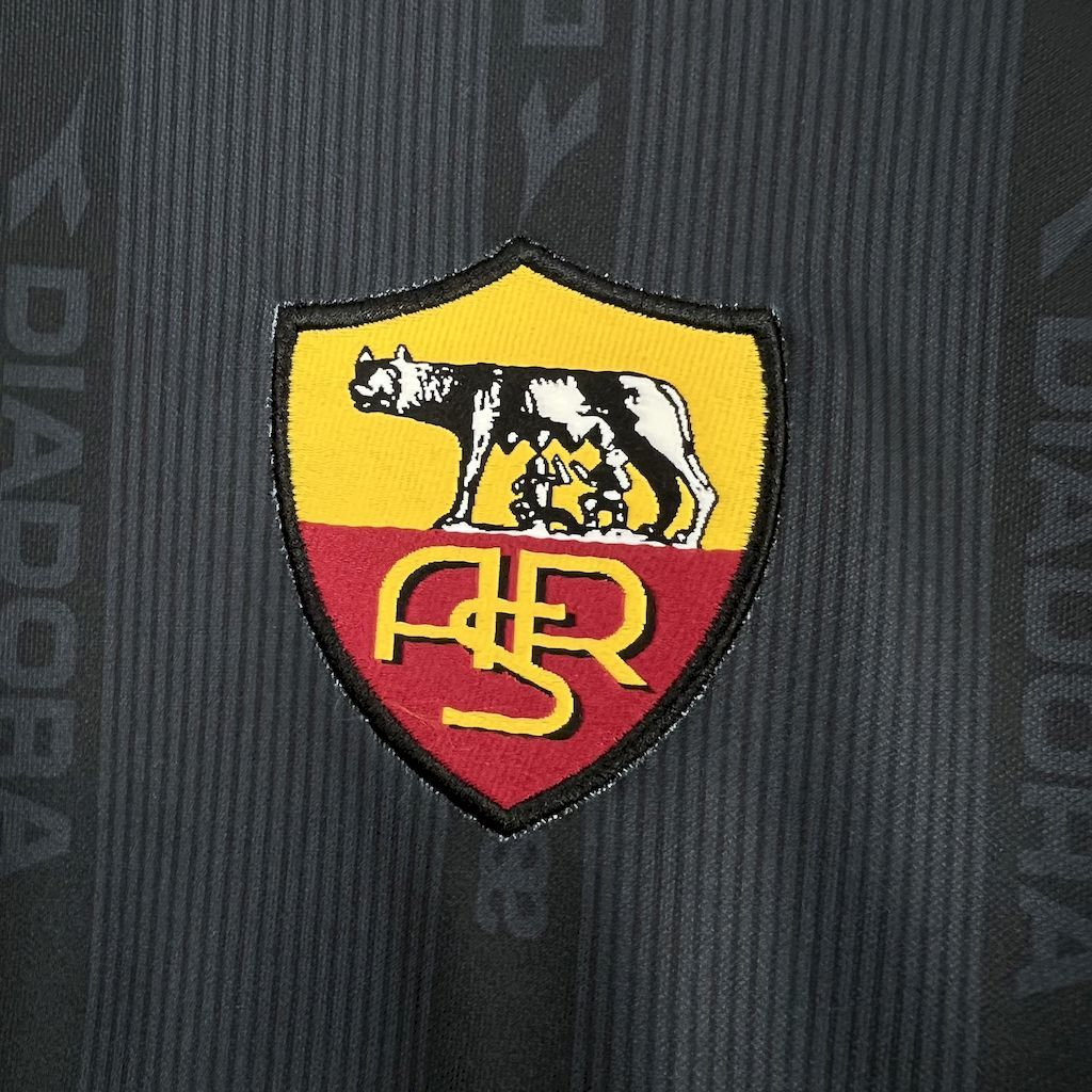 Retro football jersey crest close-up, Roma shield patch in yellow and red on navy