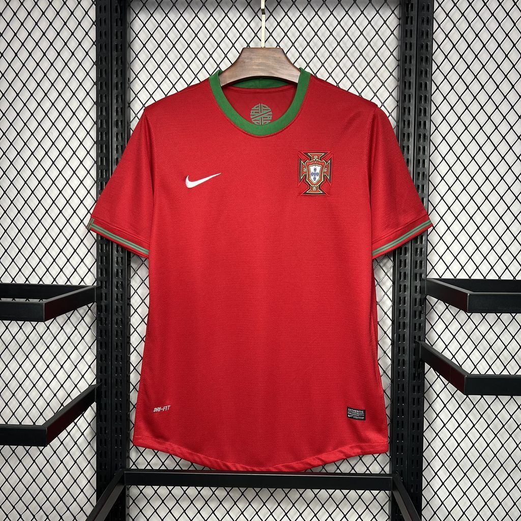 Red soccer jersey with green collar trim, Nike swoosh, Portugal crest on chest.