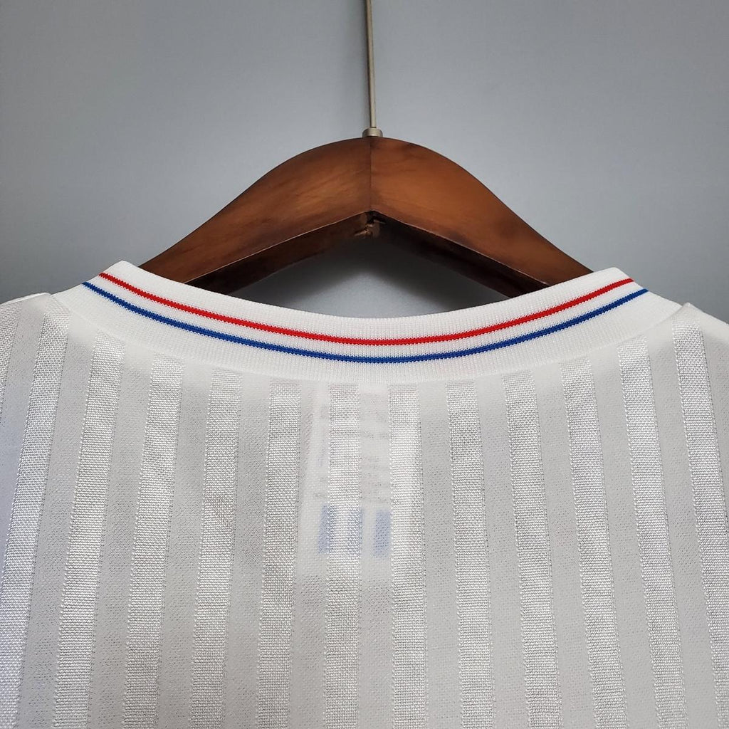 White soccer jersey collar with red and blue striped V-neck trim