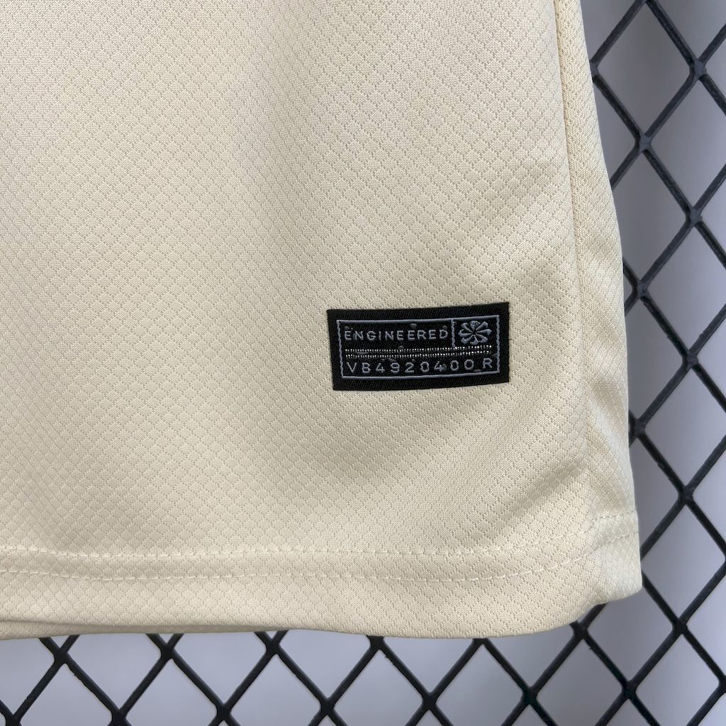 Cream kid jersey with small black tech label on the chest