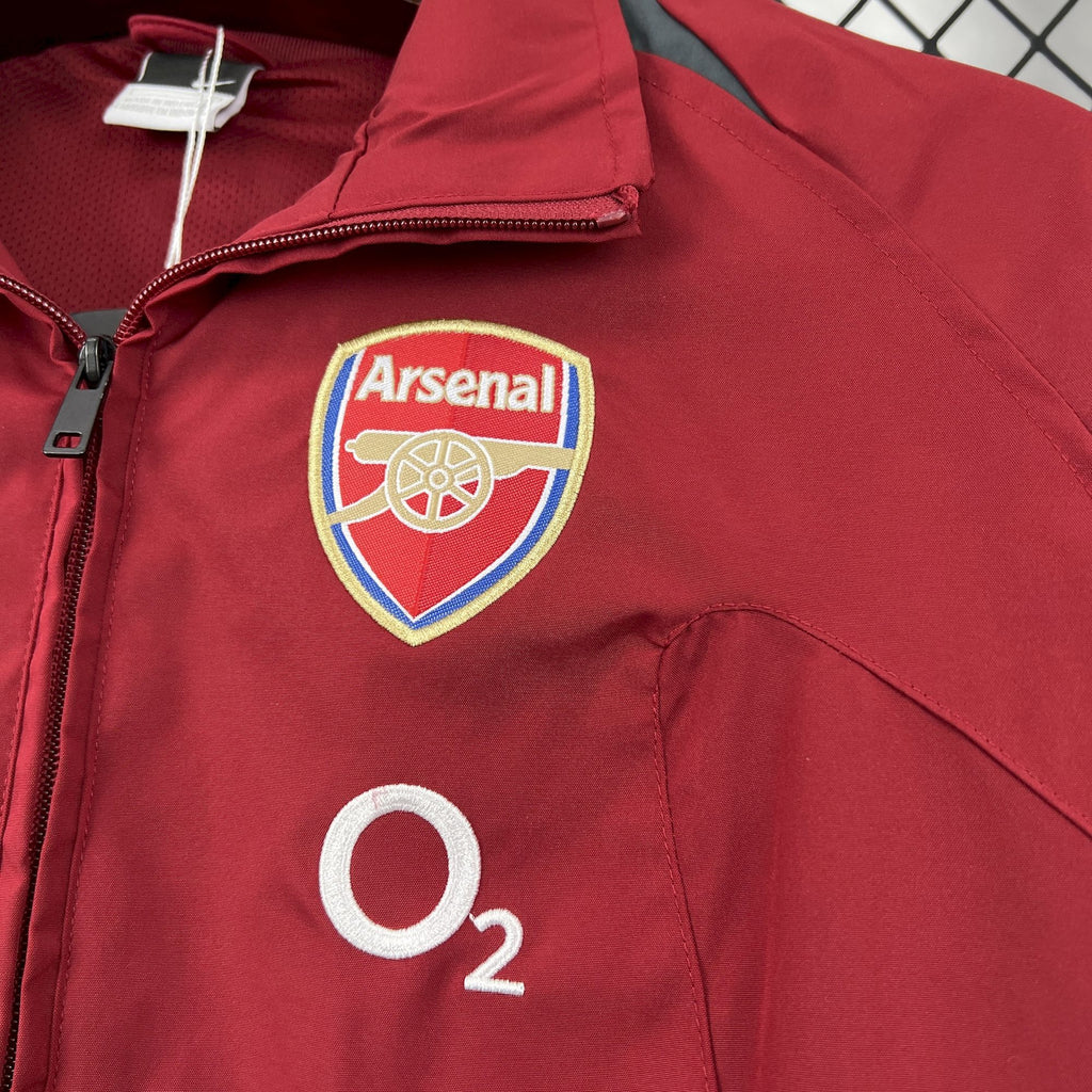 Red windbreaker jacket with Arsenal crest patch and O2 logo on chest
