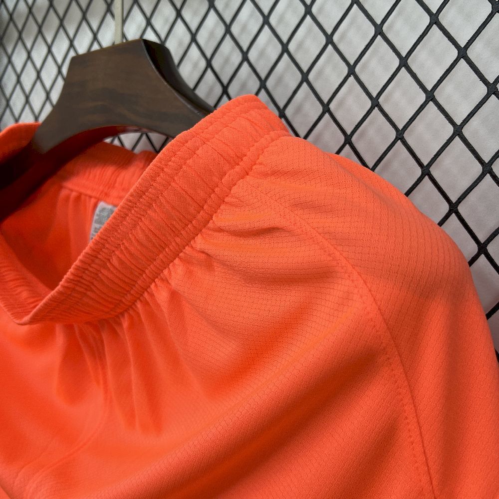 Orange football shorts with ribbed elastic waistband