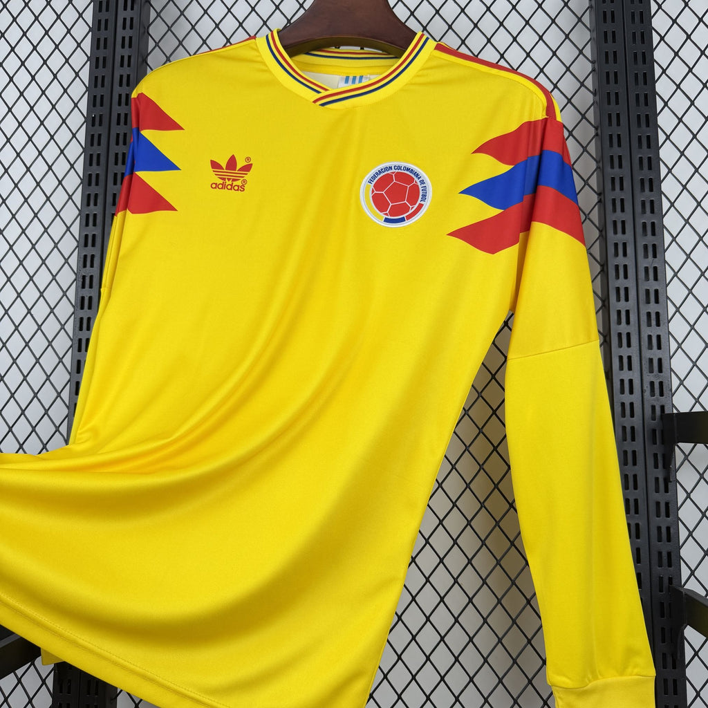 Yellow Colombia home jersey with adidas logo, red/blue shoulder accents, and ball crest
