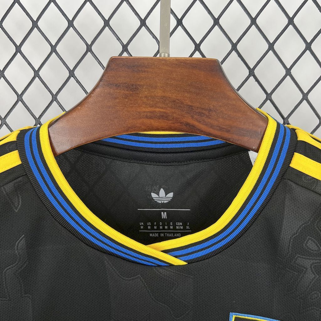 Women's third football jersey neck label, adidas-style mark on dark fabric.