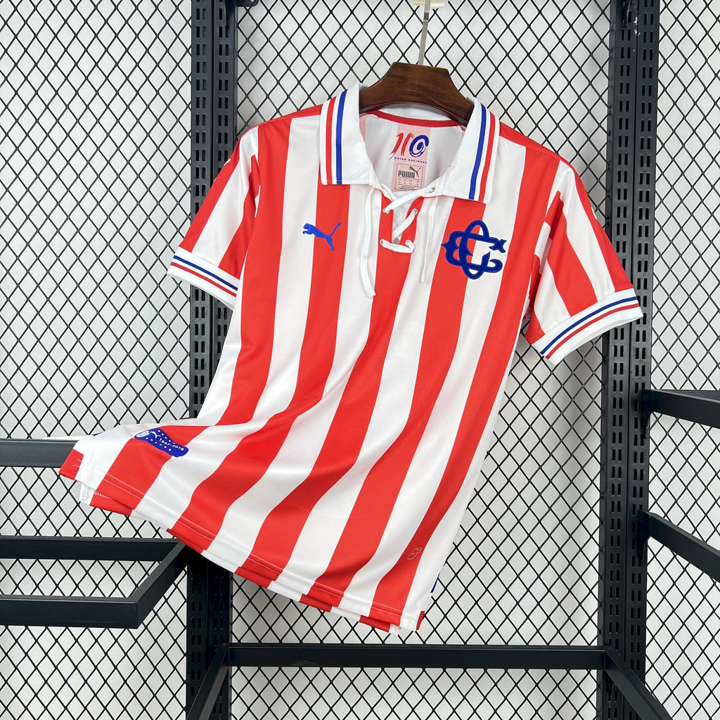 Retro soccer jersey with red-and-white vertical stripes, blue trim, and front crest.
