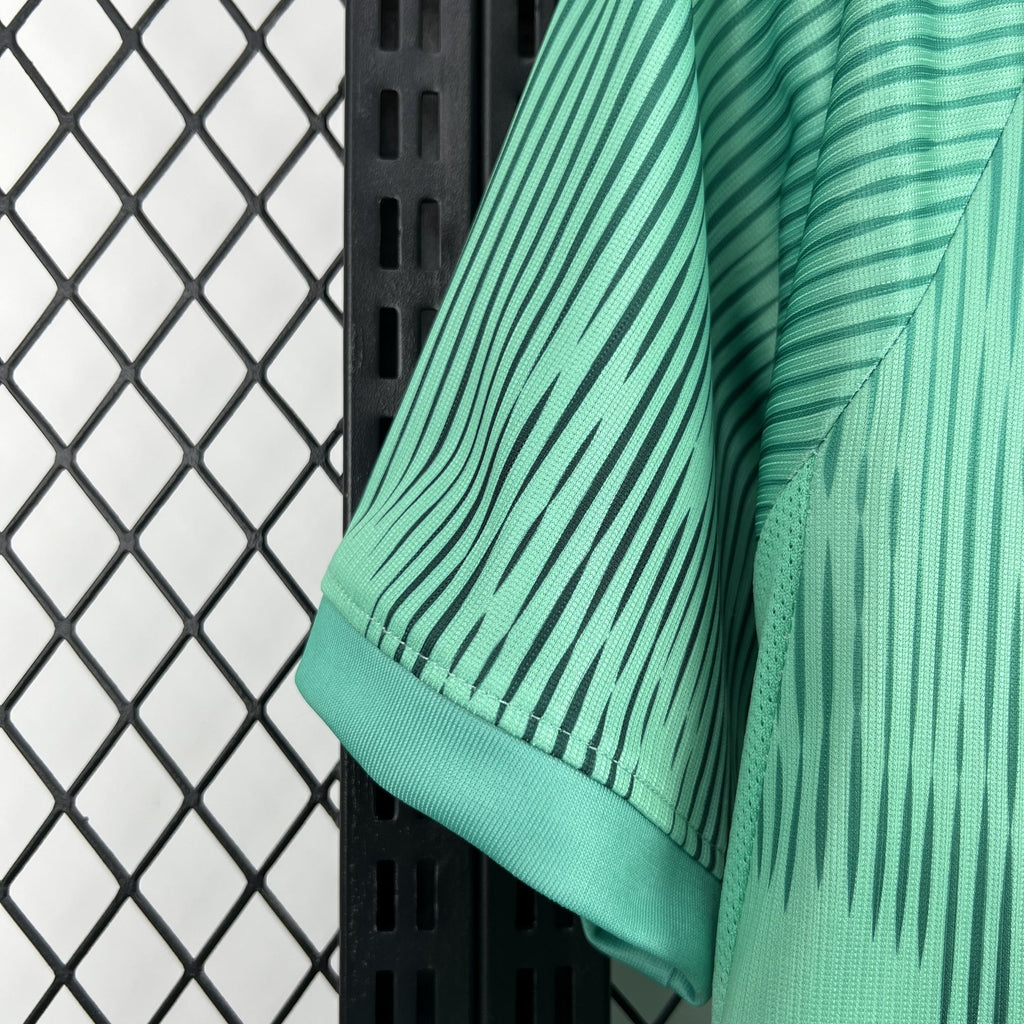 Turquoise goalkeeper fan jersey cuff and hem with ribbed black edge