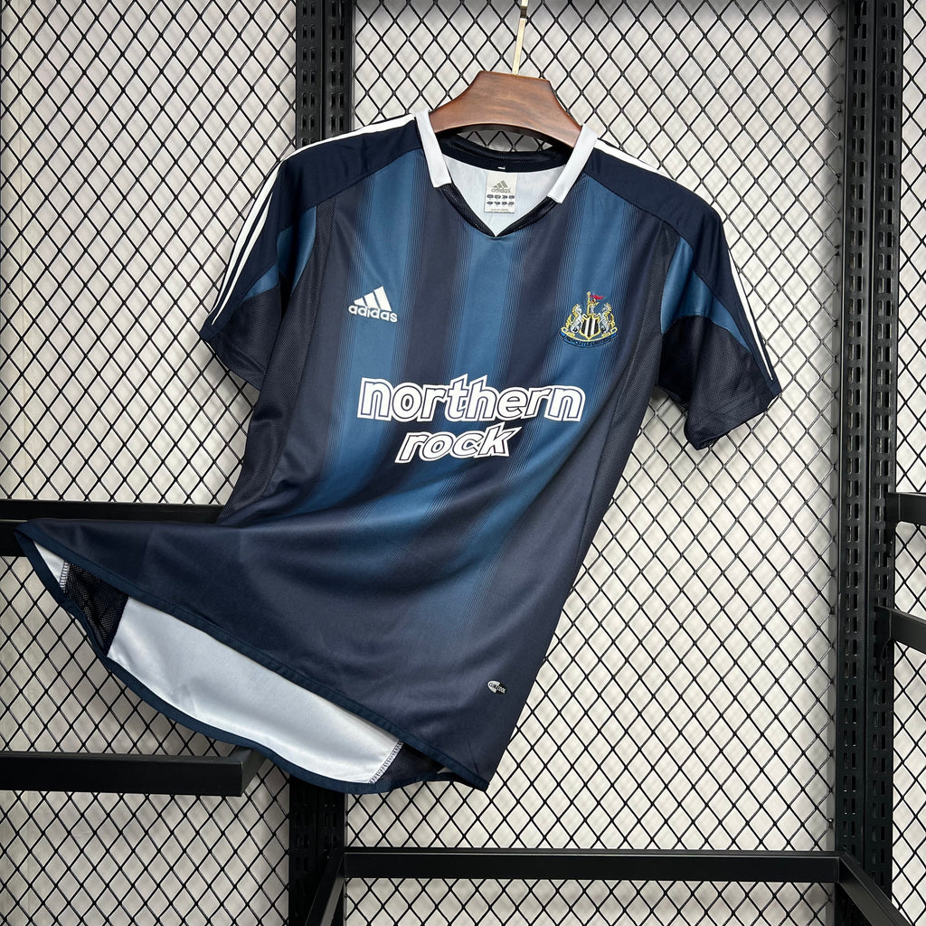 Navy and light-blue away soccer jersey, northern rock chest logo and Newcastle crest