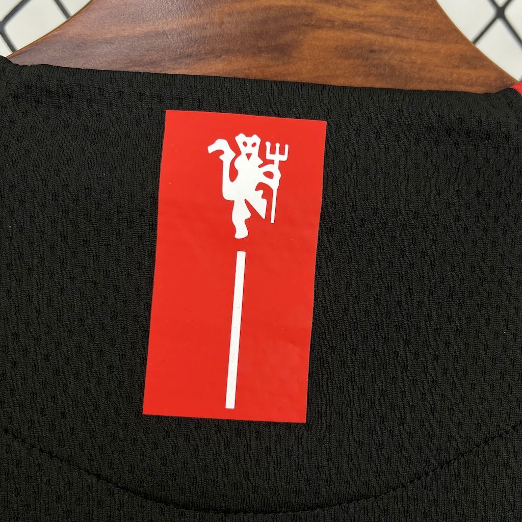 Retro away football jersey back collar label with white graphic on red background
