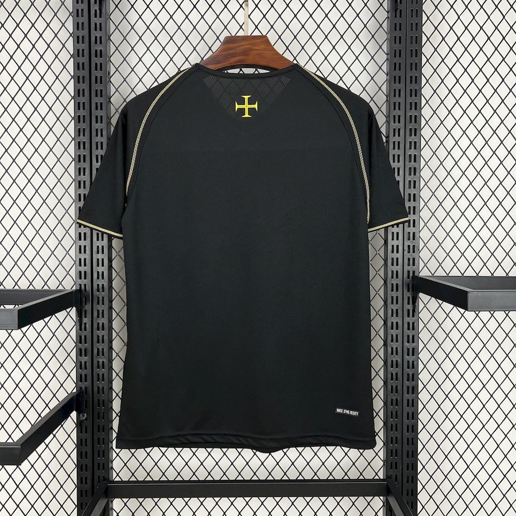 Black soccer jersey back with gold cross emblem and curved shoulder stripe detail