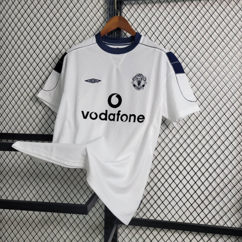 White Manchester United retro soccer jersey with blue trim, crest, and Vodafone sponsor text