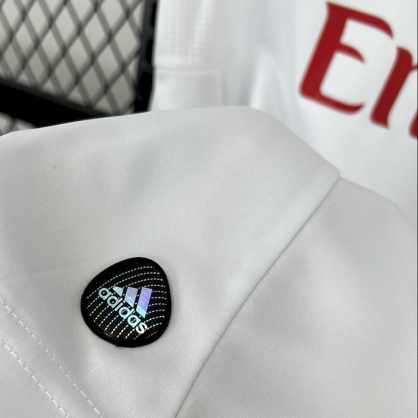 White jersey with black adidas oval patch near shoulder