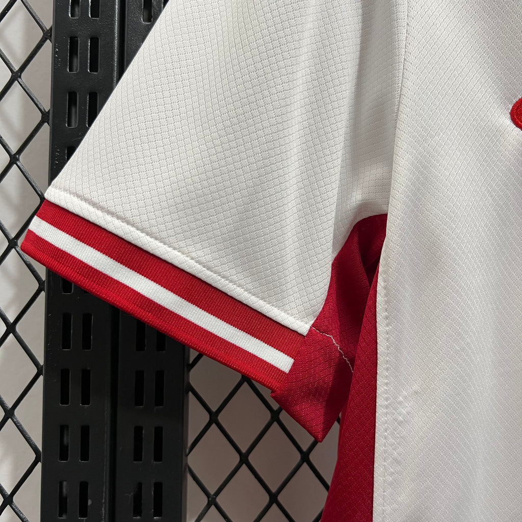 White sleeve cuff with red stripes and red inner collar lining
