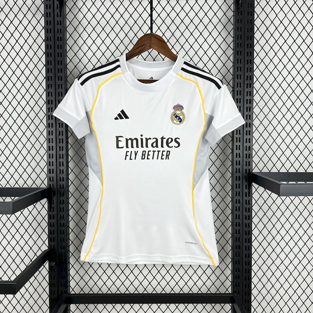 Women’s white football jersey with yellow trim, Real Madrid crest, and Emirates sponsor front