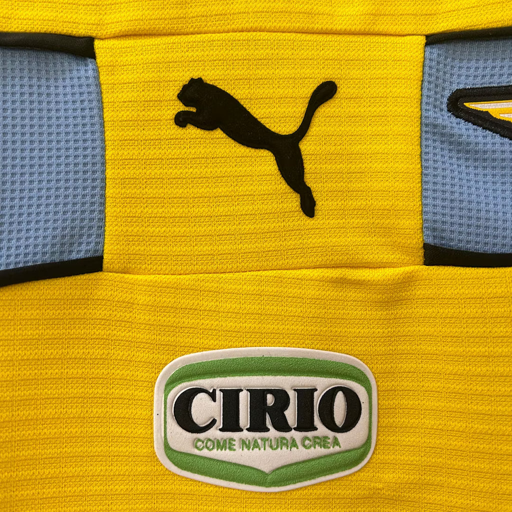 Close-up: Yellow retro jersey with black PUMA logo and CIRIO patch on chest