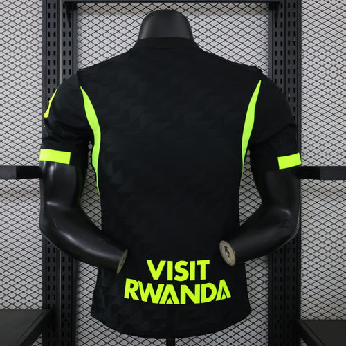 Black away football jersey back view with neon green shoulder stripes and large sponsor text