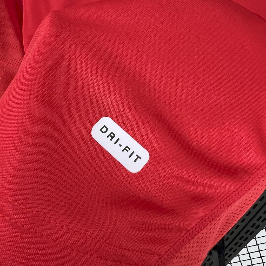 Red soccer jersey with Dri-FIT label and stitched fabric texture