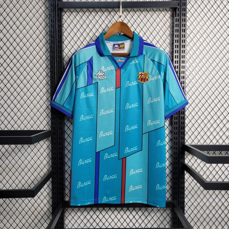 Light blue Barcelona retro football jersey with zip, purple trim, club crest and Kappa logo.