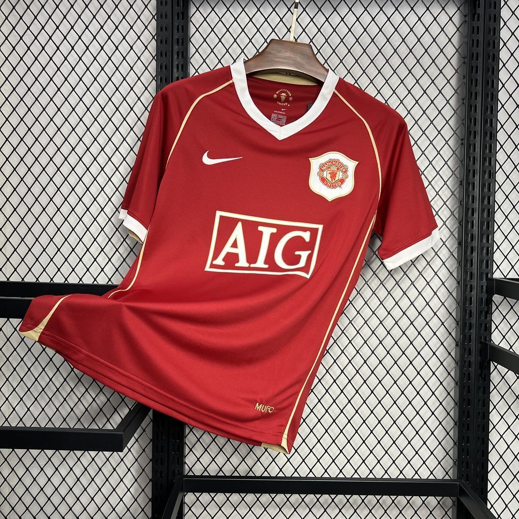 Red retro football jersey with white-trim V-neck, Manchester United crest and AIG logo