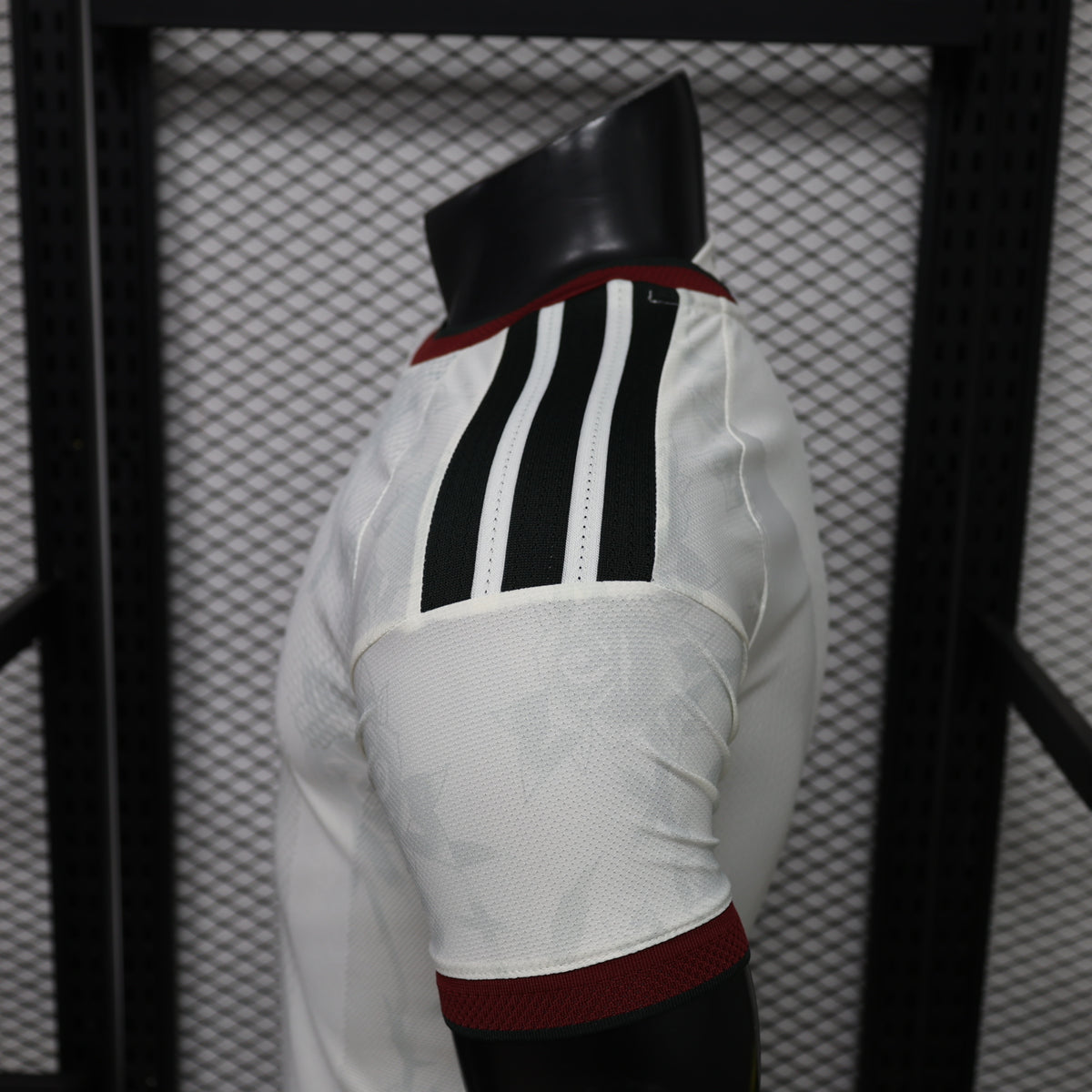 White Manchester United third player shirt back panel with black pinstripes and maroon hem