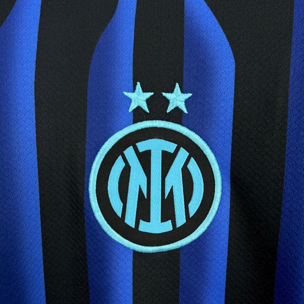 Inter Milan fan jersey crest close-up with two stars and Inter logo, blue and black stripes