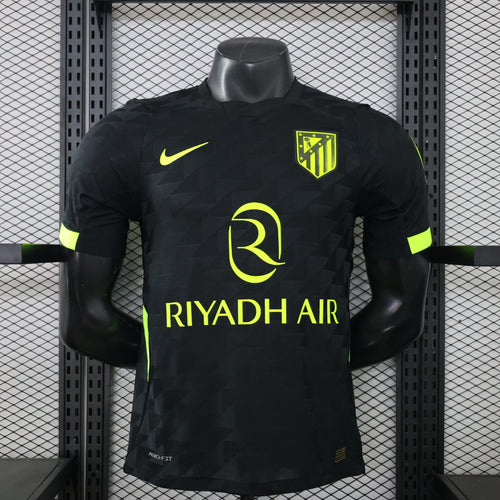Black away football jersey with neon green accents, Nike swoosh, and crest on the chest