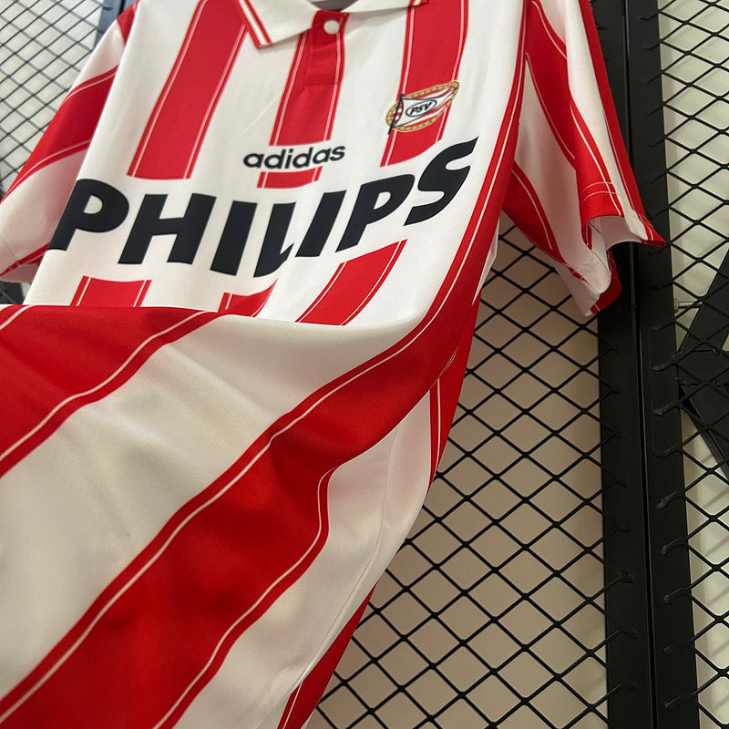 Red-and-white striped soccer jersey close-up with PHILIPS sponsor and adidas mark