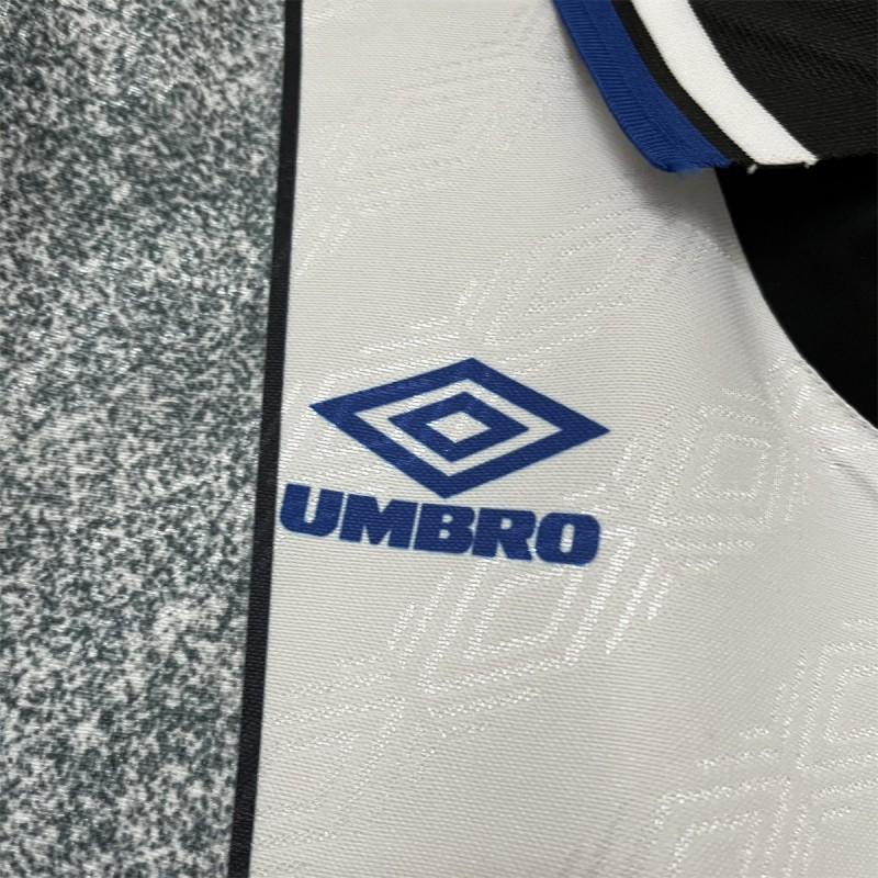 Umbro logo patch on retro away jersey, white fabric with black side panel and blue logo