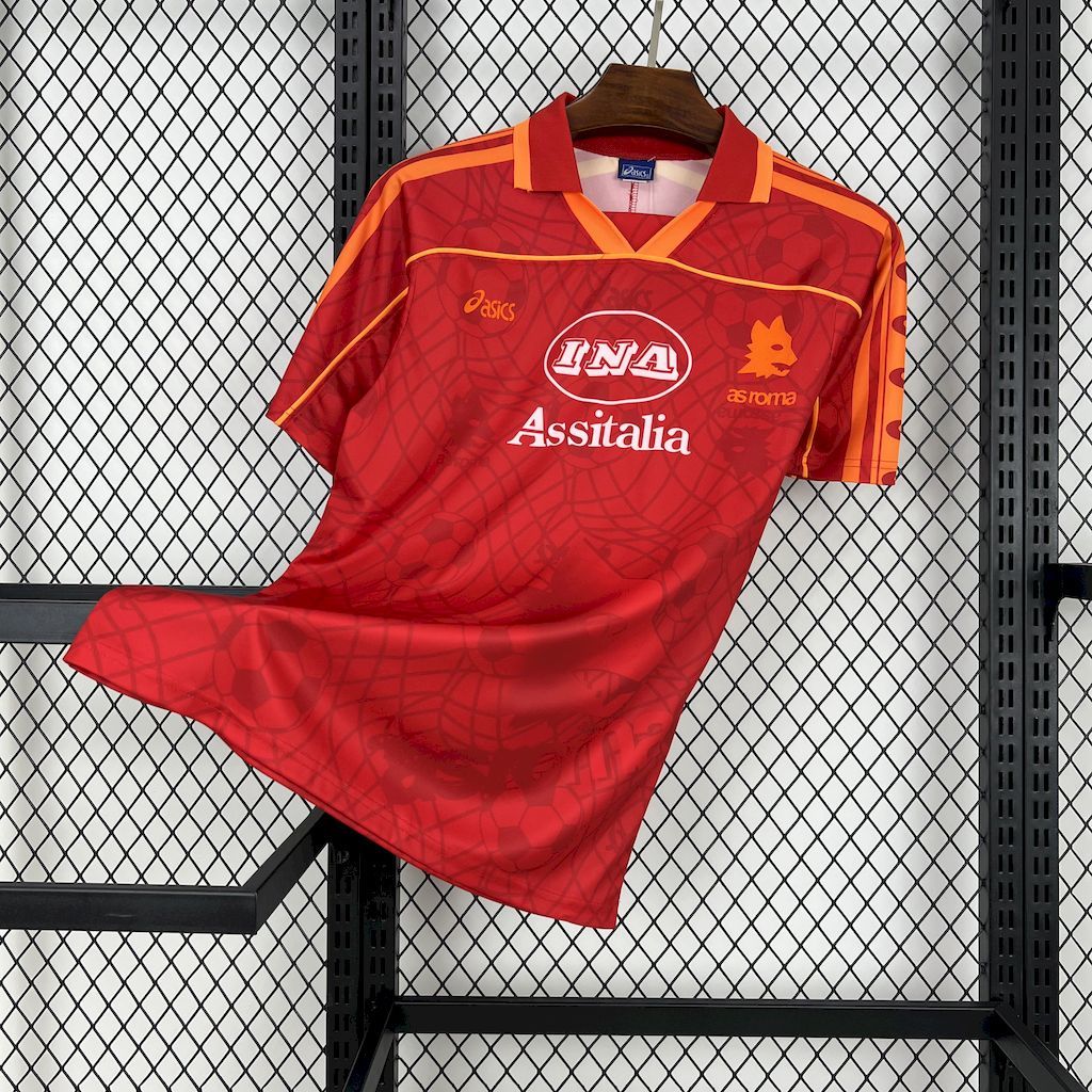 Red soccer home jersey with orange trim, IN A crest, and As sitalia sponsor print.