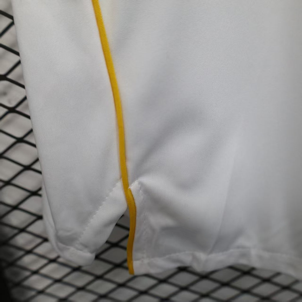 White shorts hem with yellow contrast piping and stitched finish.