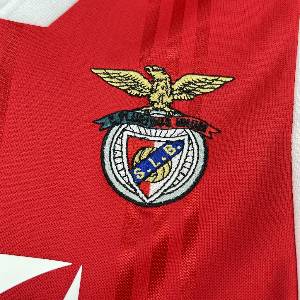 Benfica crest emblem on red soccer jersey with textured fabric