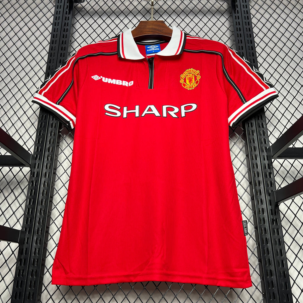 Red soccer jersey front view with white collar, Umbro logo, SHARP sponsor, and crest