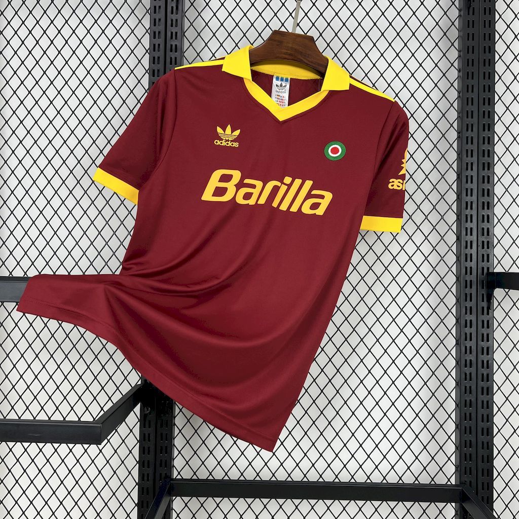 Maroon Roma home football jersey on hanger with yellow collar and Barilla sponsor