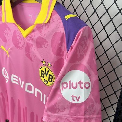Pink goalkeeper jersey with yellow trim, BVB crest, and pluto tv sleeve logo