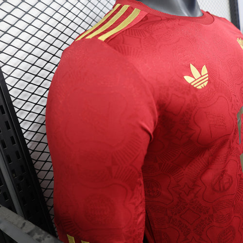 Red long-sleeve football jersey with gold shoulder stripes and adidas logo on sleeve