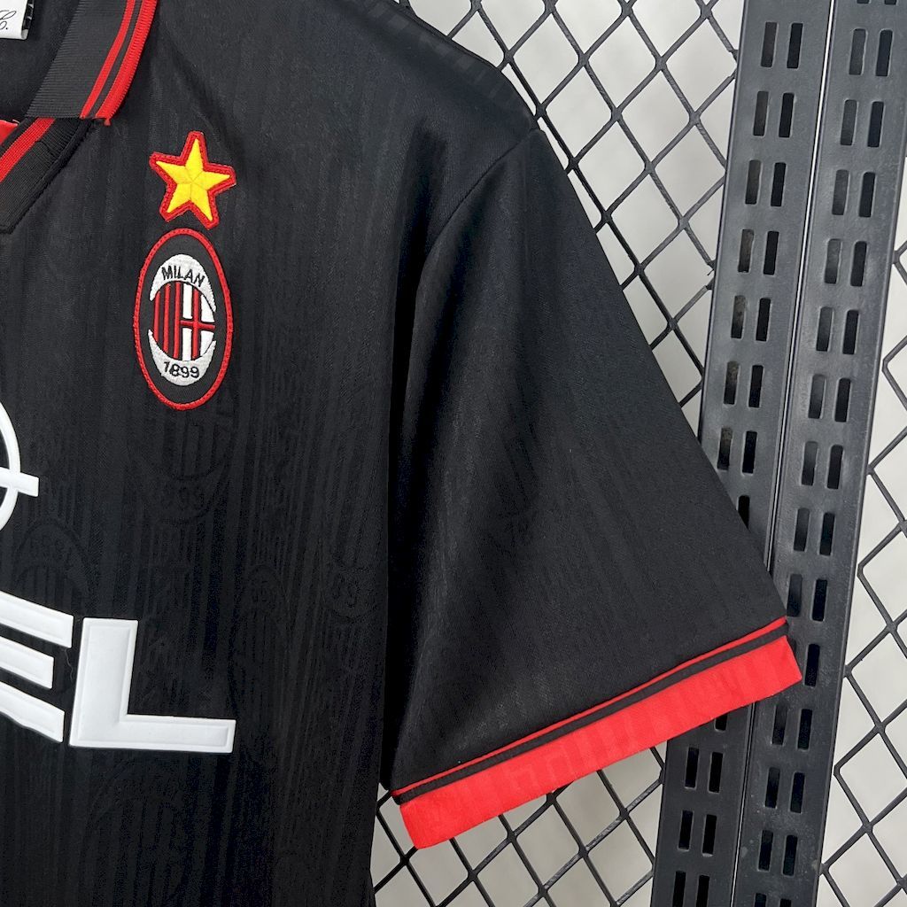 Black jersey sleeve with Milan crest and red star applique