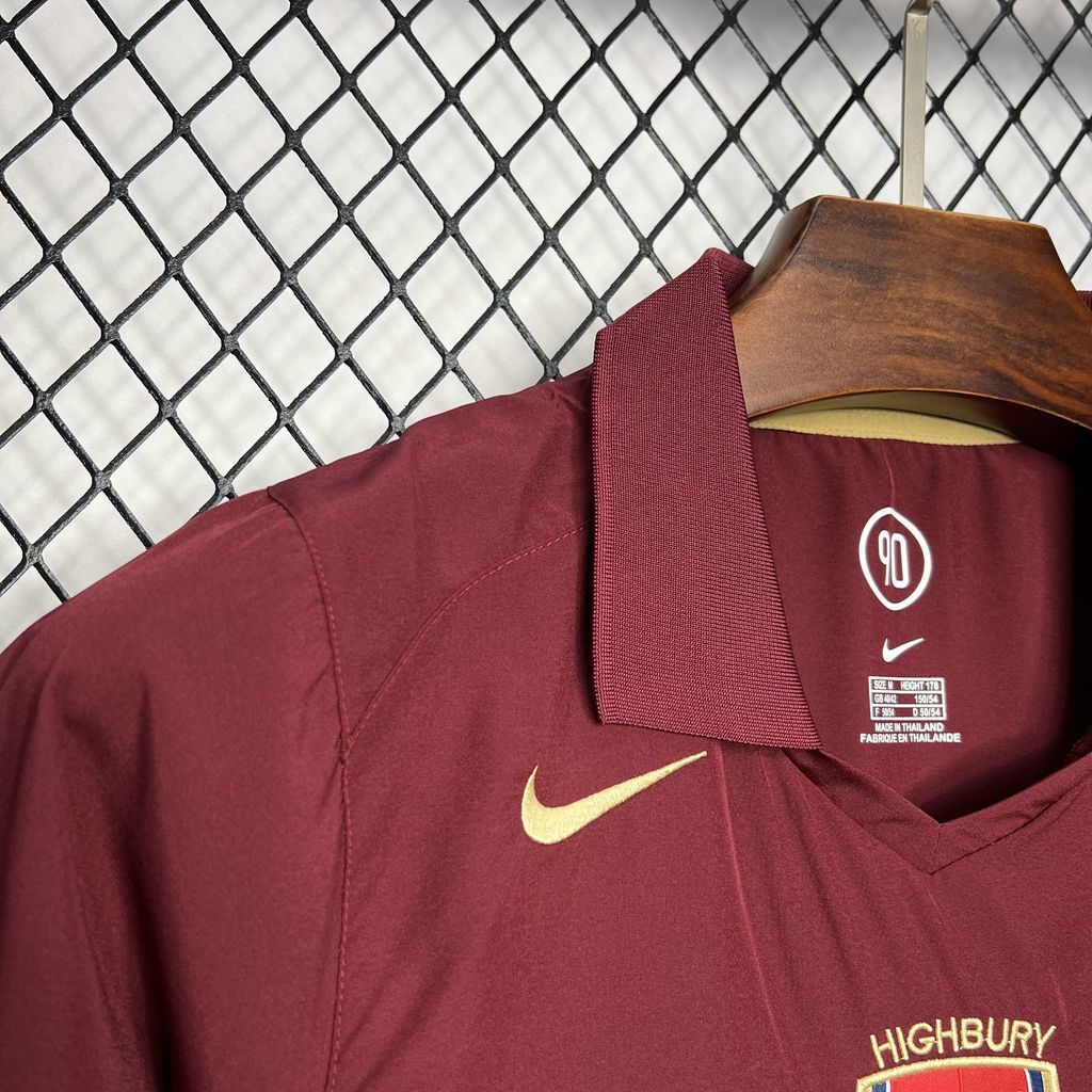 Maroon football jersey collar with Nike swoosh and crest badge