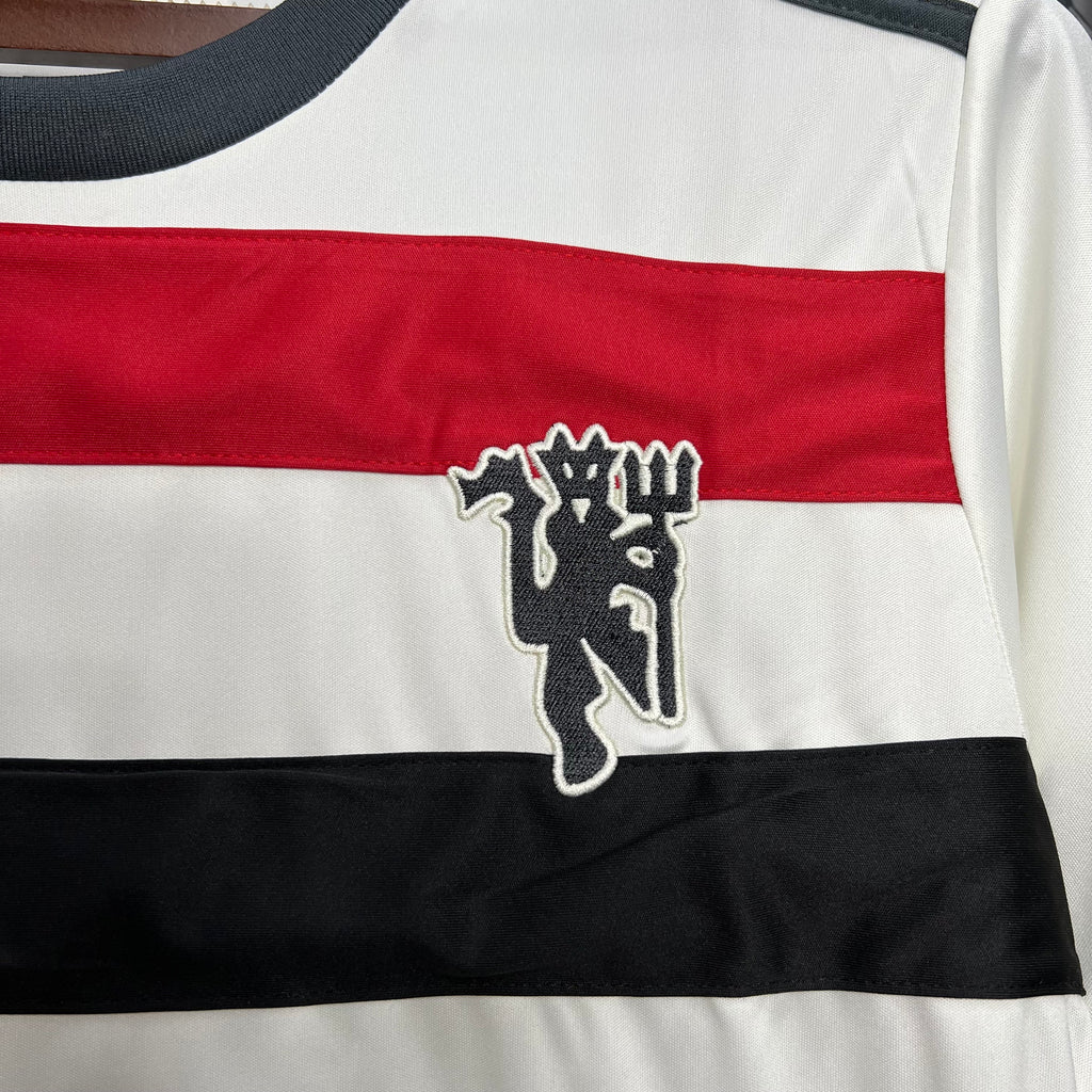 White third football jersey chest close-up with Manchester United lion crest