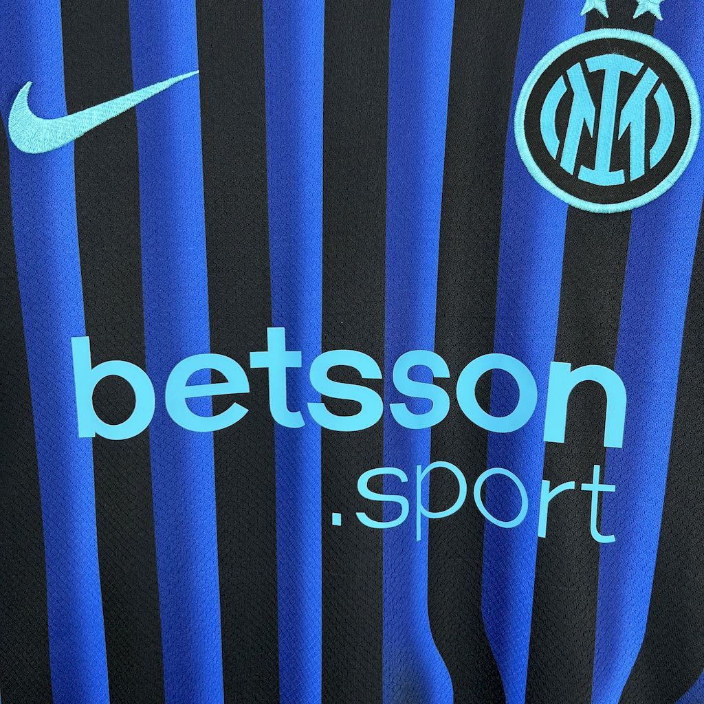 Inter Milan fan jersey close-up of betsson sponsor and Nike swoosh, blue-and-black stripes
