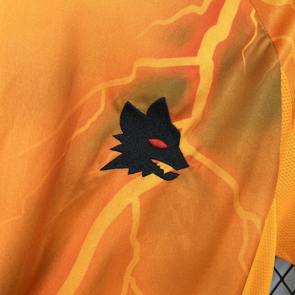 Orange soccer jersey fabric with black team crest and light lightning pattern