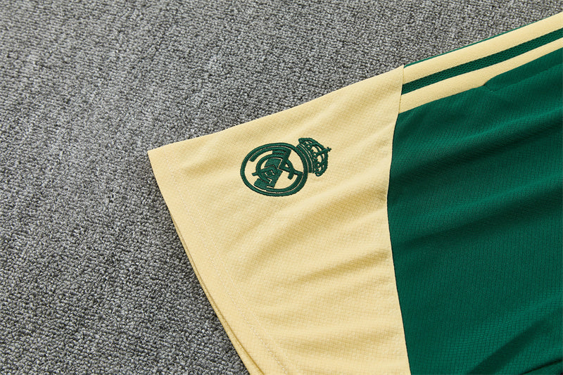 Green and cream shorts with Real Madrid crest badge near the corner