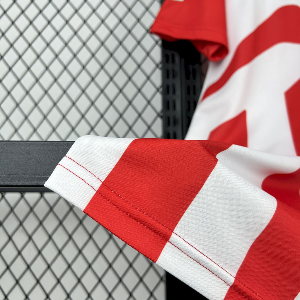 Retro soccer jersey sleeve cuff with red-and-white stripes and blue edge trim