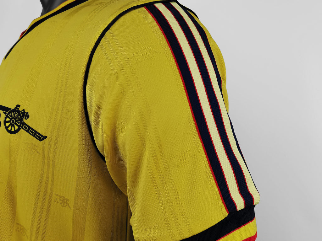 Yellow jersey sleeve with navy side stripes and red accent band